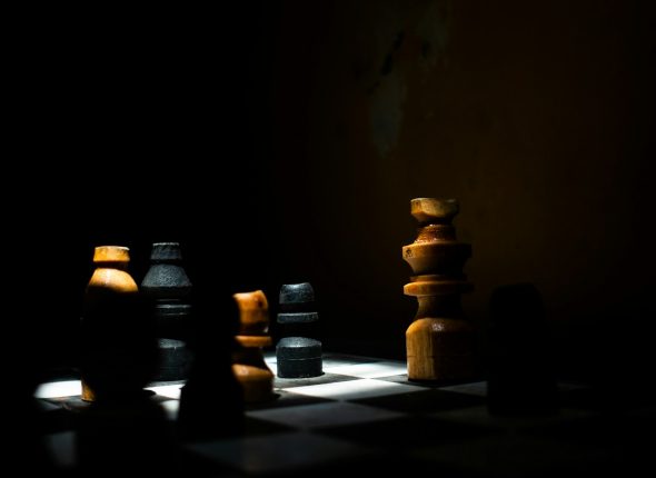 a group of chess pieces sitting on top of a chess board